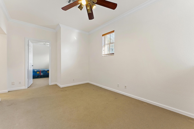 carpeted spare room featuring ceiling fan and ornamental molding