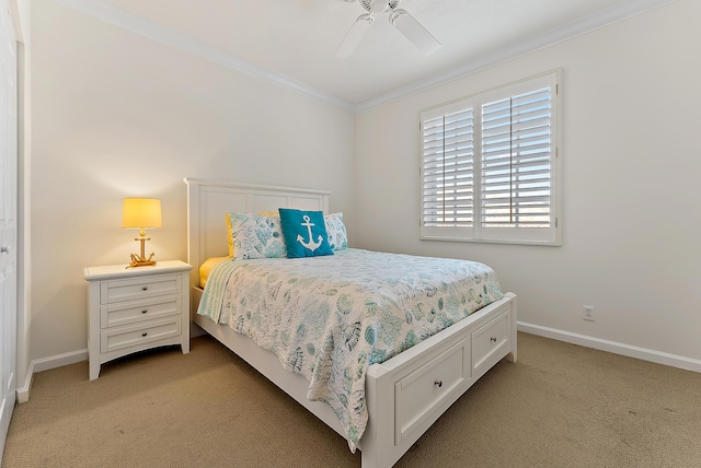 carpeted bedroom featuring crown molding and ceiling fan