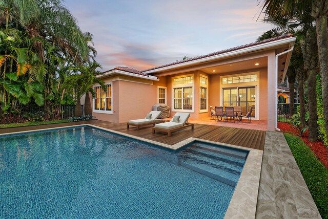 view of pool at dusk