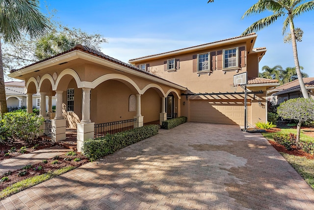 mediterranean / spanish-style home with a garage