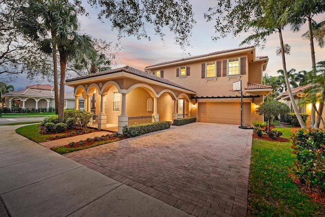 mediterranean / spanish-style house with a porch and a garage