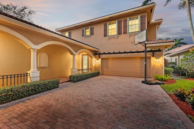 mediterranean / spanish house with a garage