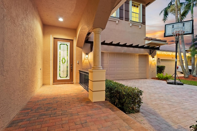 exterior entry at dusk with a garage