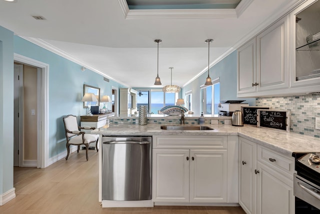 kitchen featuring appliances with stainless steel finishes, decorative backsplash, white cabinetry, and sink