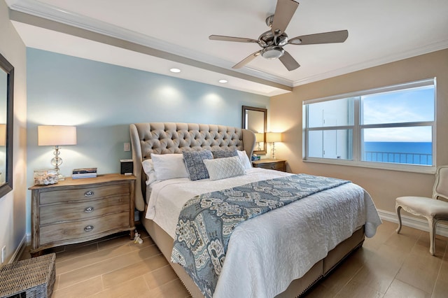 bedroom featuring ceiling fan, ornamental molding, and a water view