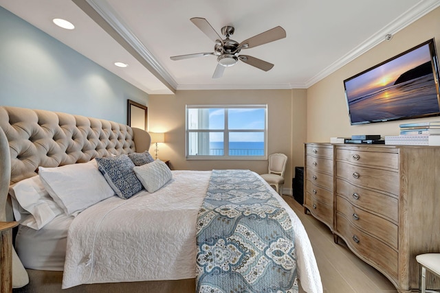 bedroom featuring ceiling fan, crown molding, and light hardwood / wood-style flooring