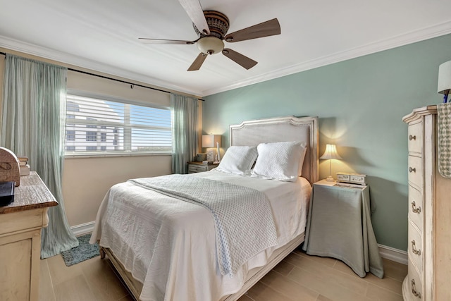 bedroom with ceiling fan and crown molding