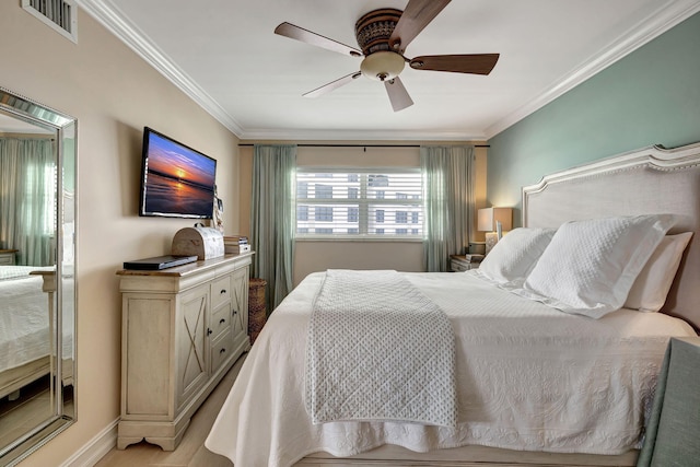 bedroom featuring ceiling fan, light wood-type flooring, and ornamental molding