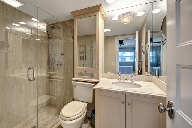 bathroom featuring vanity, ceiling fan, toilet, and walk in shower