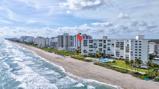 drone / aerial view with a water view, a view of city, and a view of the beach