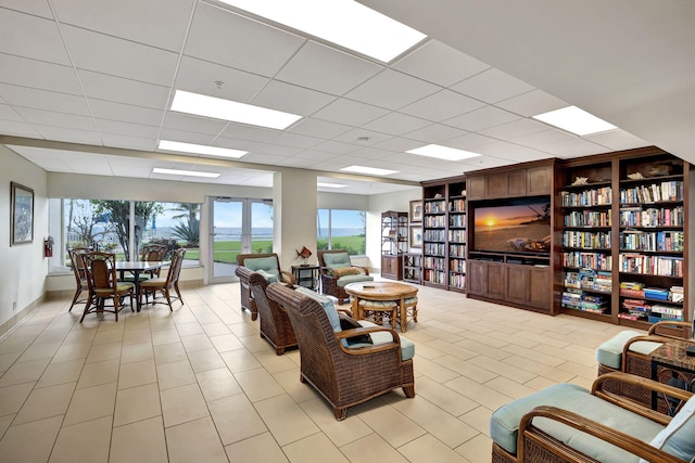 living room with a drop ceiling