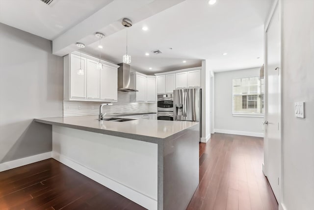 kitchen featuring kitchen peninsula, white cabinets, hanging light fixtures, and stainless steel refrigerator with ice dispenser