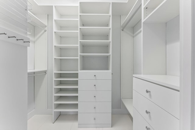 spacious closet featuring light tile patterned floors