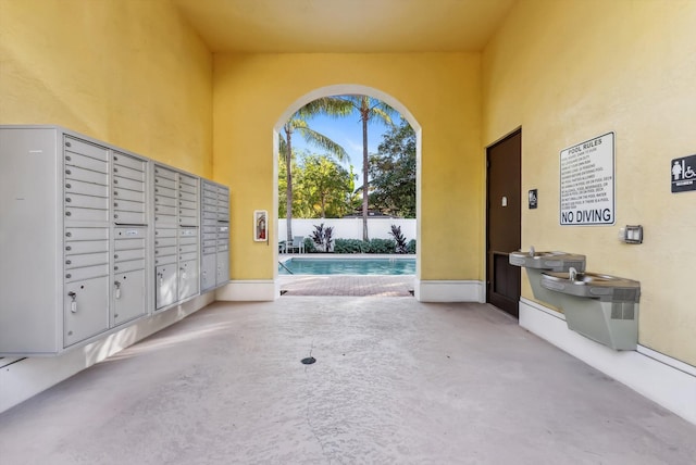 view of property's community with mail boxes and a pool