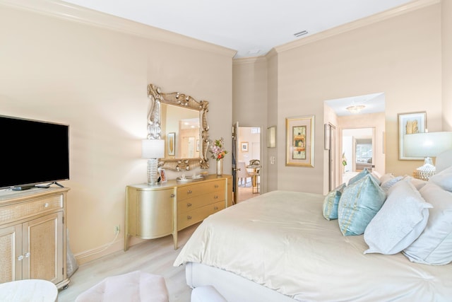 bedroom featuring light hardwood / wood-style floors and ornamental molding