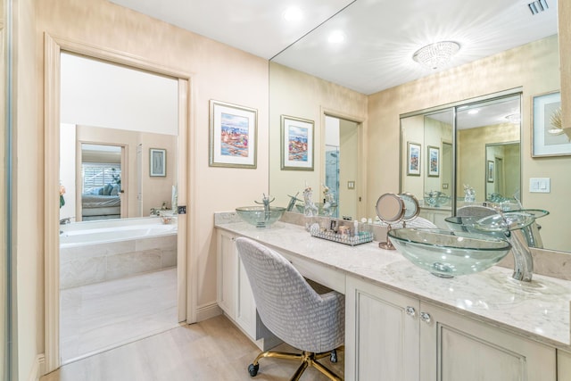 bathroom with vanity and wood-type flooring