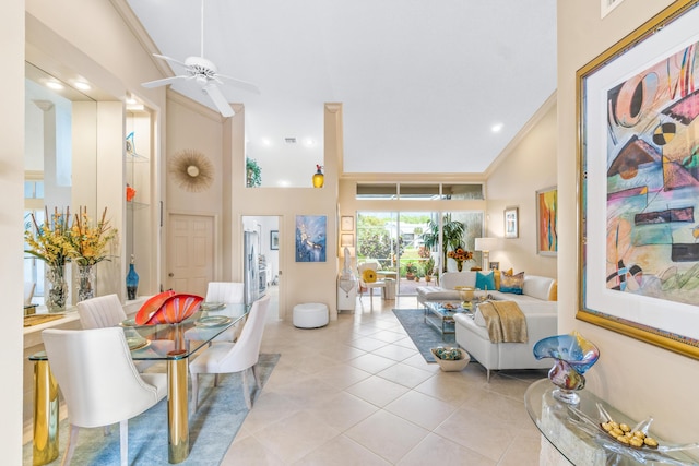 living room featuring ceiling fan, light tile patterned floors, ornamental molding, and high vaulted ceiling