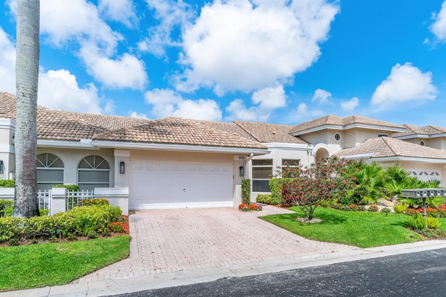 view of front of house featuring a front yard and a garage