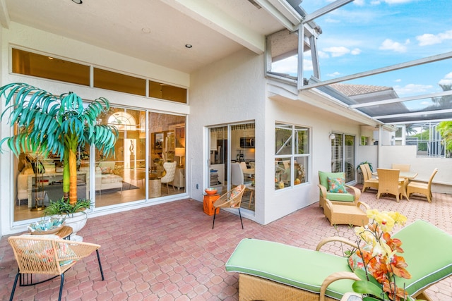 view of patio / terrace featuring glass enclosure