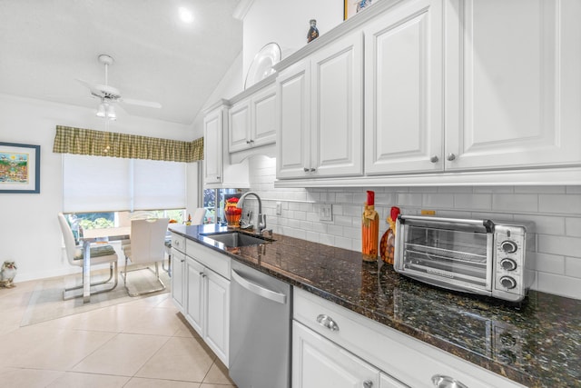 kitchen featuring dishwasher, dark stone counters, white cabinets, sink, and ornamental molding