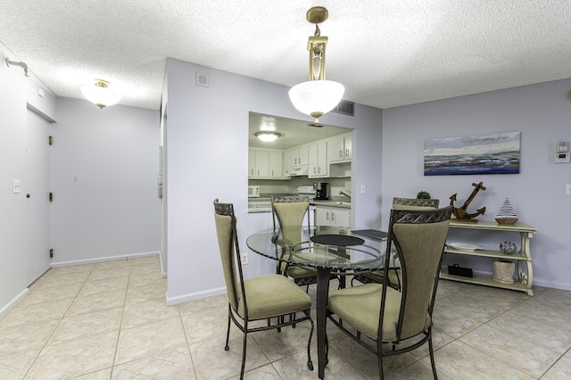 dining room with sink and a textured ceiling