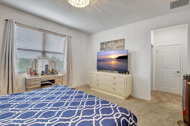 bedroom featuring a notable chandelier and light carpet