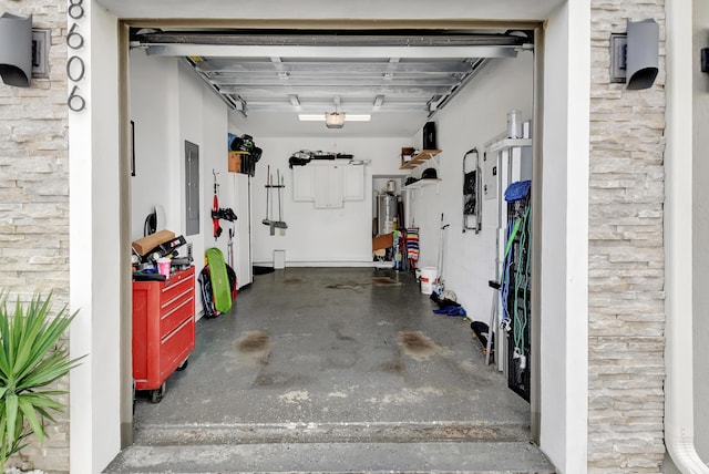 garage with a garage door opener, electric water heater, and electric panel