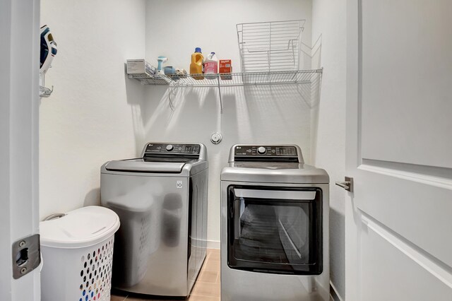 clothes washing area with washing machine and dryer