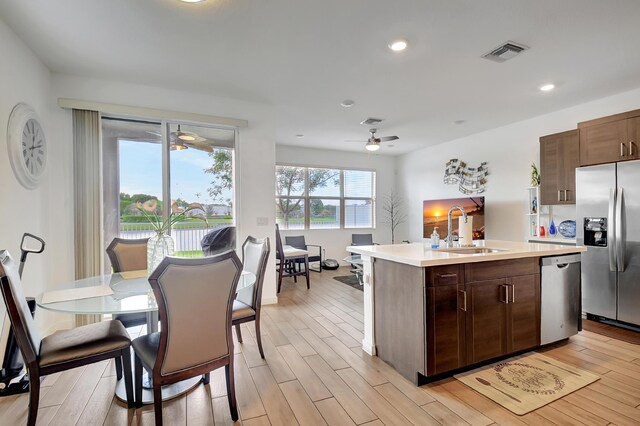 kitchen featuring sink, stainless steel appliances, and light hardwood / wood-style flooring