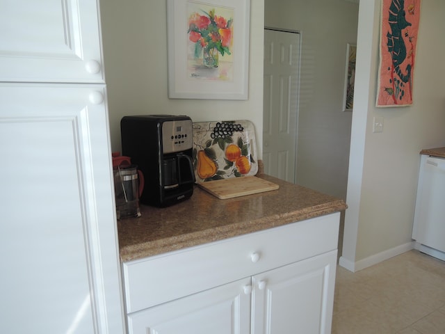 kitchen featuring white cabinetry, white dishwasher, and light tile patterned floors