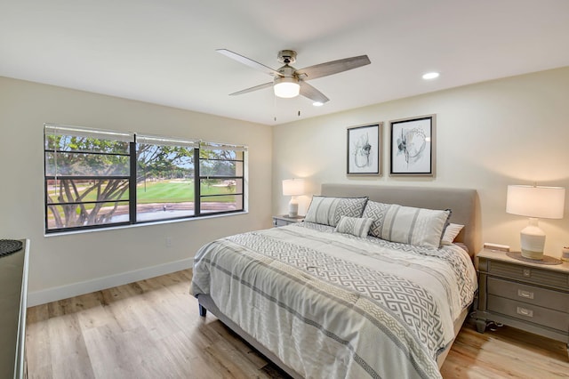 bedroom with light hardwood / wood-style floors and ceiling fan