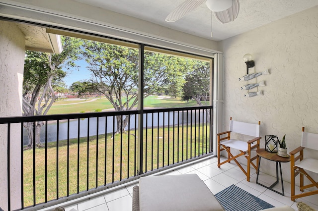 sunroom featuring ceiling fan