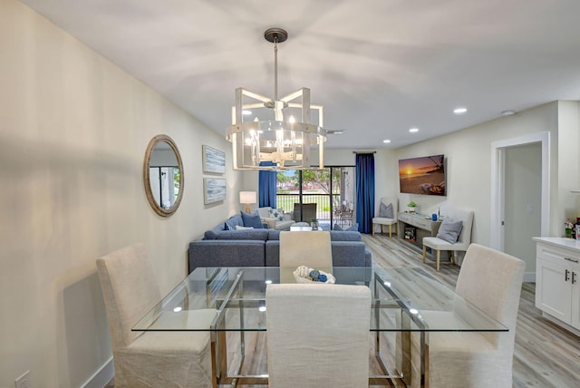 dining room featuring a notable chandelier and light wood-type flooring