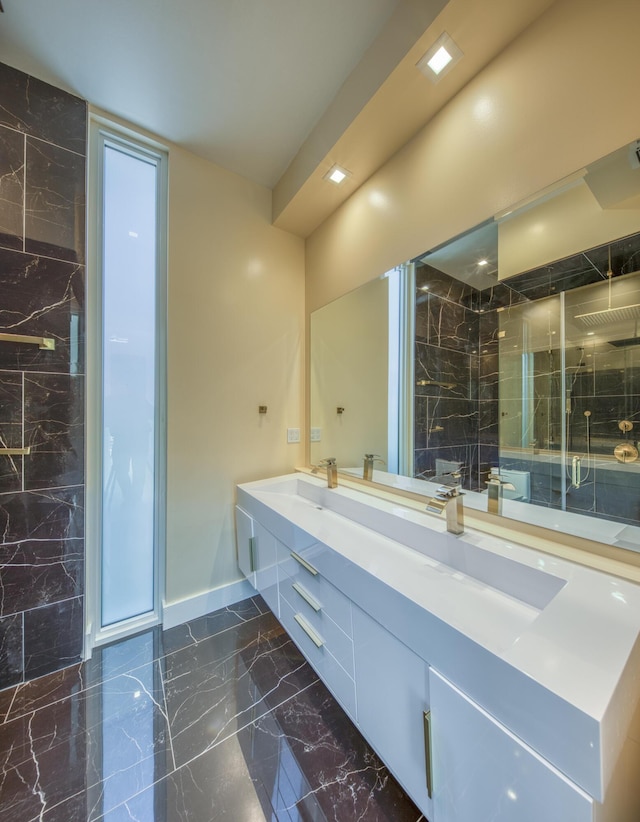 bathroom with vanity and a shower with door