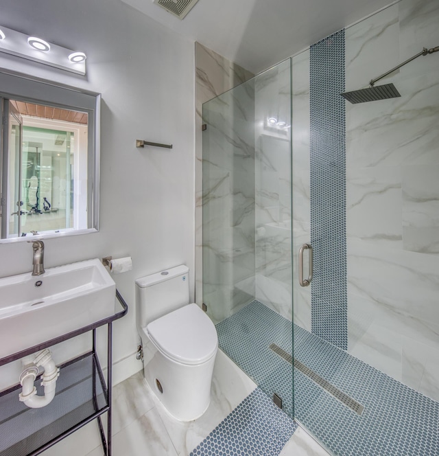 bathroom with tile patterned floors, toilet, an enclosed shower, and sink