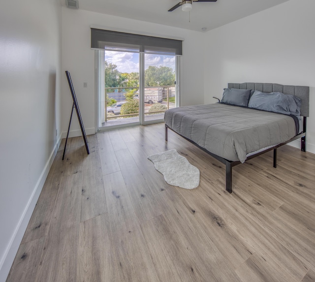 bedroom featuring access to outside, light hardwood / wood-style floors, and ceiling fan