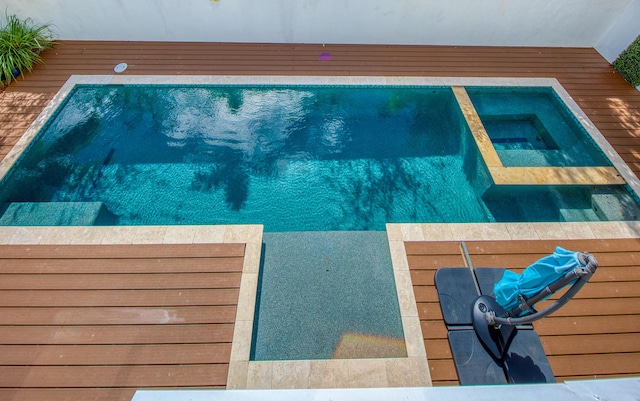 view of swimming pool featuring an in ground hot tub