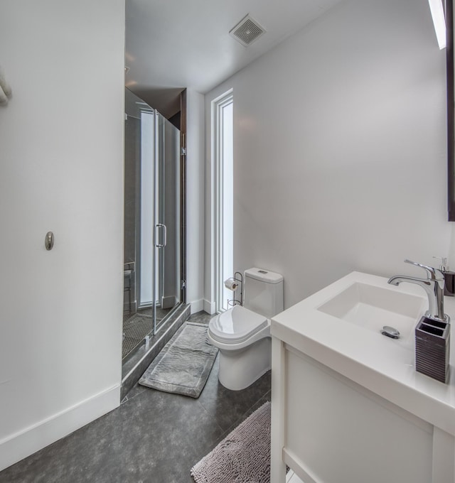 bathroom with an enclosed shower, vanity, and toilet