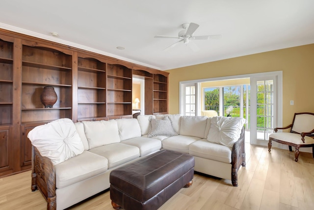 living room featuring ceiling fan and light wood-type flooring