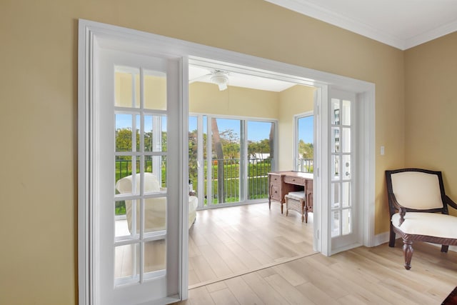 entryway featuring ornamental molding and light hardwood / wood-style flooring