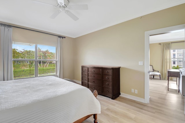 bedroom with light hardwood / wood-style flooring, multiple windows, and ceiling fan