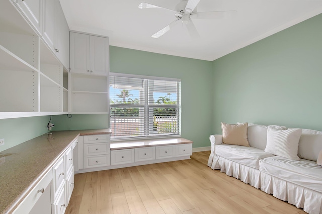 interior space with white cabinetry, light hardwood / wood-style flooring, and ceiling fan