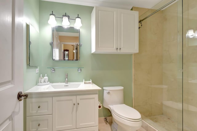 bathroom featuring a tile shower, vanity, and toilet