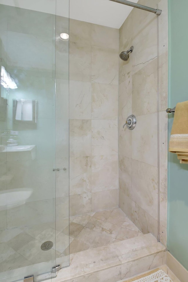 bathroom with a tile shower