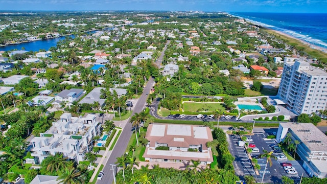 birds eye view of property with a view of the beach and a water view