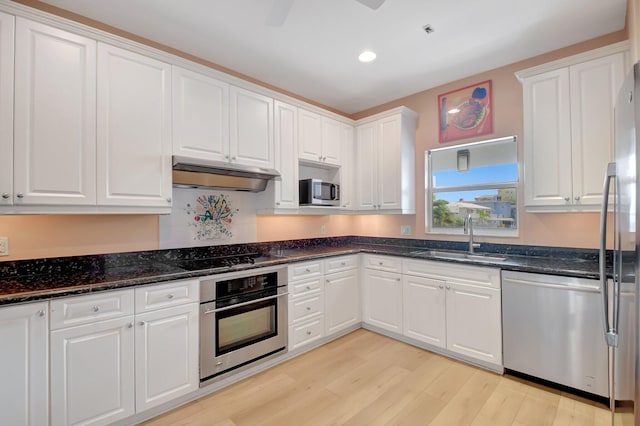 kitchen with stainless steel appliances, white cabinetry, and sink