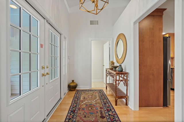 entryway featuring a notable chandelier and light wood-type flooring