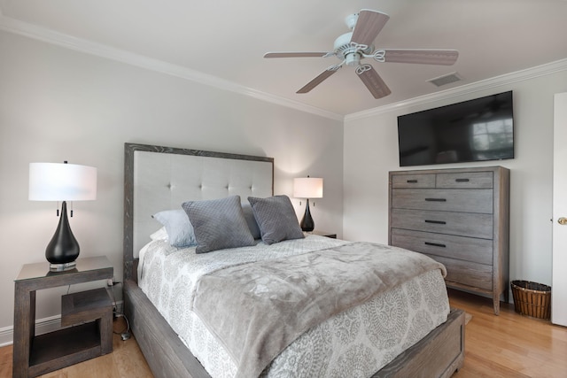 bedroom with light wood-type flooring, ceiling fan, and crown molding