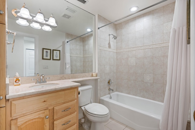 full bathroom featuring tile patterned flooring, vanity, toilet, and shower / bathtub combination with curtain