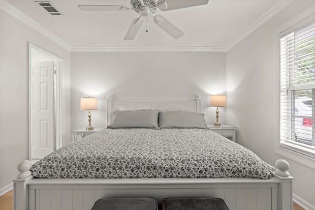 bedroom with ceiling fan, hardwood / wood-style floors, and ornamental molding